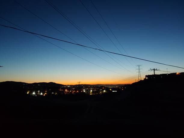 istock Sunset with orange sky and electricity cables in the sky 1416046205