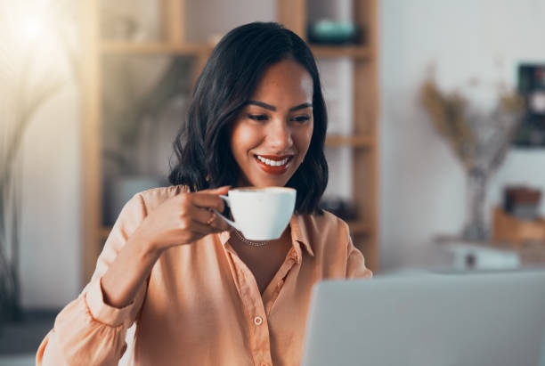istock Coffee, reading female freelancer, work from home or remote worker on laptop replying to copywriting emails. Trendy, young and smiling woman on social media or browsing internet for online news 1416047881