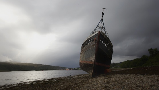 Moody photo of the shipwreck on Caol Beach, near Fort William, Scotland, UK