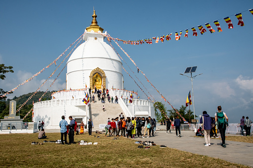 Pokhara, Nepal - nov  2, 2019: the World Peace Stupa, destination for thousands of Buddhist pilgrims, stands on a hill overlooking Lake Phewa, Pokhara, Nepal