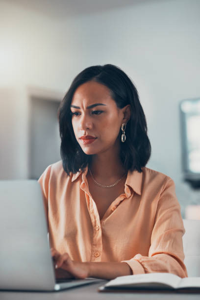 istock Working from home, serious and thinking woman, freelancer and entrepreneur doing remote work while planning ideas, email and browsing research online. Organized, professional and focused worker 1416051727