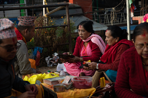 Narayanthan, Kathmandu, Nepal - nov 06, 2019: a Brahmin talks to two Hindu women in the Budhanilkantha temple in Kathmandu