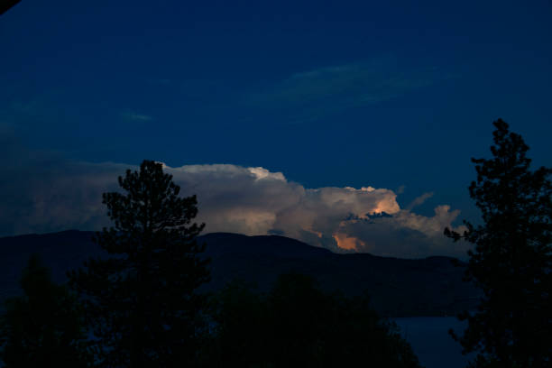 PEACHLAND, BC - AUGUST 11:  Sheet lightning lights up the clouds above Lake Okanagan in Peachland, BC Canada as the final Sturgeon moon rises behind the clouds. (Photo by Marissa Baecker/Shoot the Breeze)