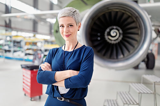 Aircraft in the under the hangar roof aviation industrial on maintenance, outside the gate bright light