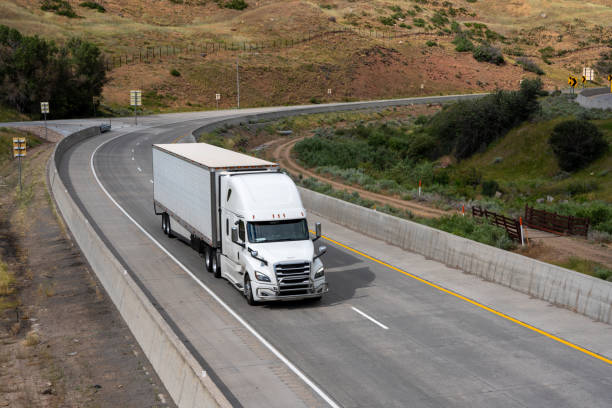 istock White Semi Truck on A Two Lane Highway 1416056892