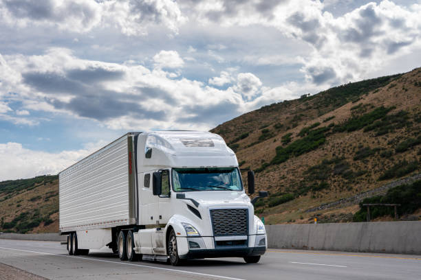 istock White Semi Truck on A Two Lane Highway 1416057596