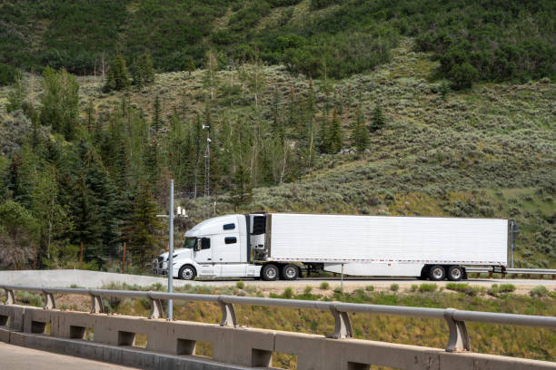 istock White Semi Truck on A Two Lane Highway 1416057650