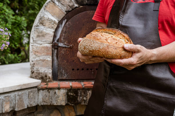 istock Homemade fresh bread in the baker's hand 1416057946