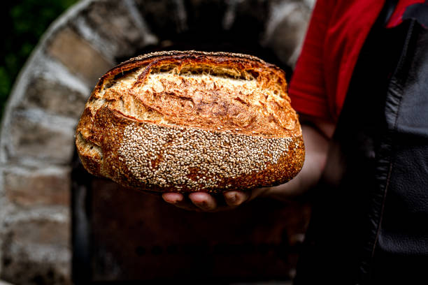 istock Homemade fresh bread in the baker's hand 1416057947