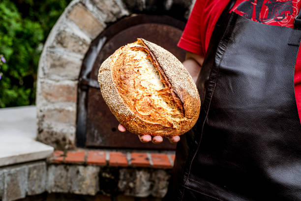 istock Homemade fresh bread in the baker's hand 1416057949