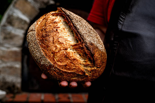 istock Homemade fresh bread in the baker's hand 1416057956