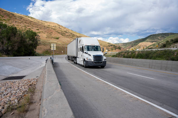 istock White Semi Truck on A Two Lane Highway 1416058059