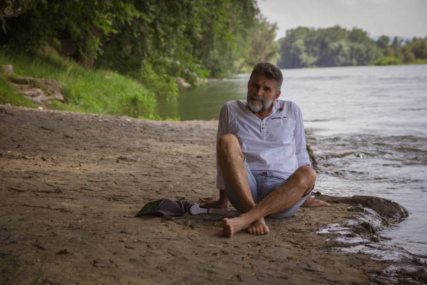 istock Mature silver beard man enjoy close to river 1416058092