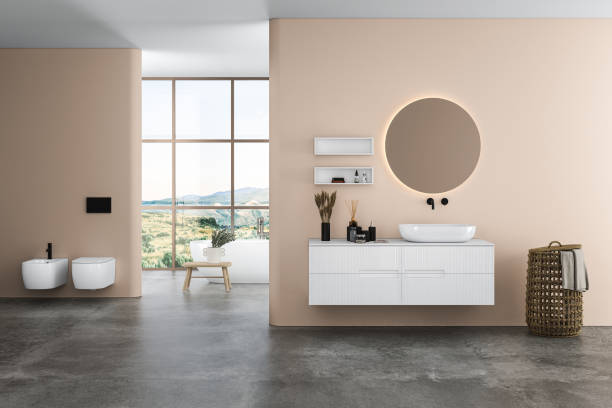istock Modern bathroom interior with beige walls, ceramic basin with oval  mirror, 1416060396