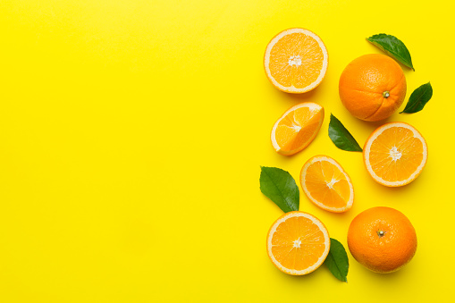 fresh Fruit orange slices on colored background. Top view. Copy Space. creative summer concept. Half of citrus in minimal flat lay with copy space.