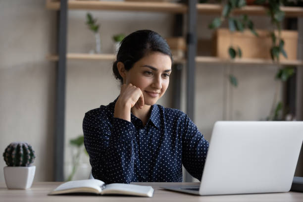 istock Happy pensive young Indian businesswoman working on computer. 1416065762