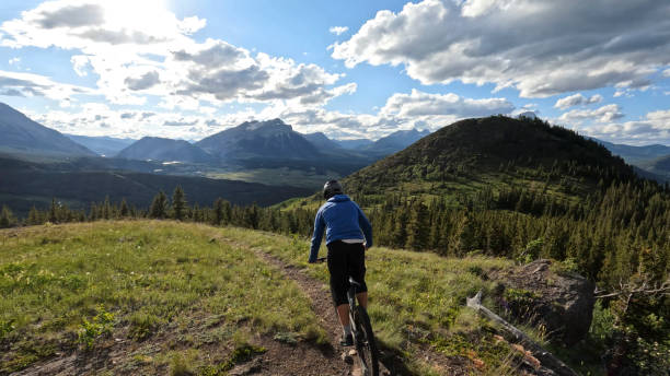 istock Young man mountain bikes on single track trail in mountains 1416066483