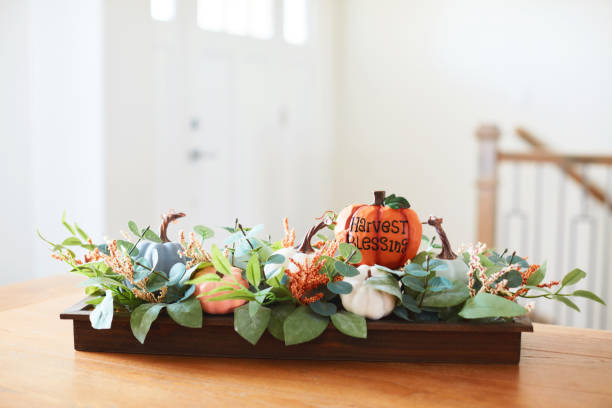 istock Fall dining room with Thanksgiving centerpiece and HARVEST BLESSINGS message in a bright modern home 1416068010