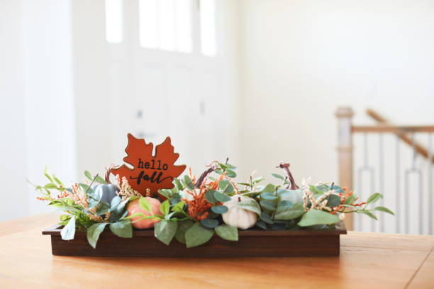 istock Fall dining room with Thanksgiving centerpiece in a bright modern home and HELLO FALL greeting 1416068035
