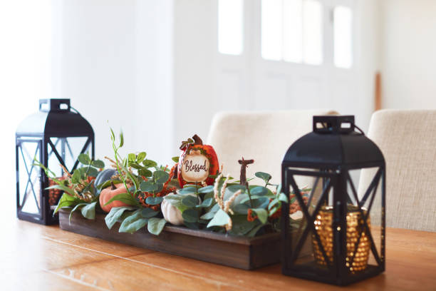 istock Fall dining room with lanterns and Thanksgiving centerpiece in a bright modern home 1416068048