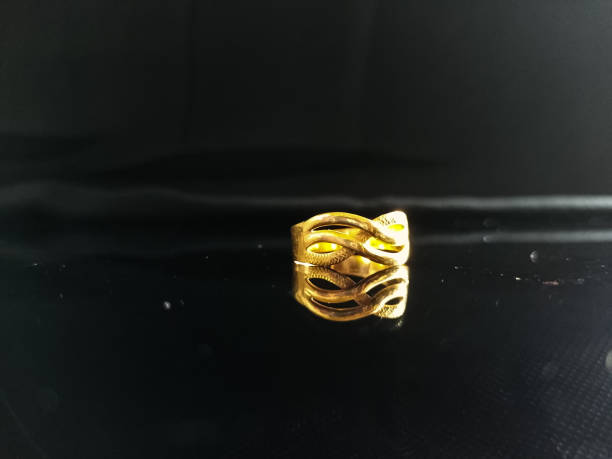 istock isolated gold ring on black background and there is reflection 1416072318
