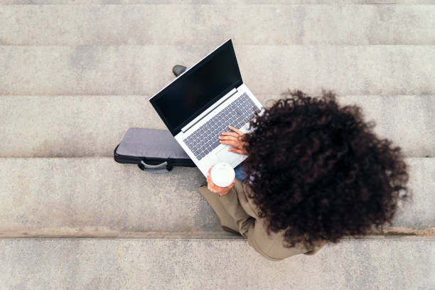 istock top view of a woman working outdoors with computer 1416088890