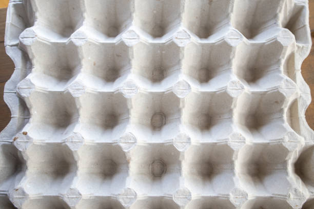 istock Top view of an empty cardboard egg tray. Background texture of a container made of biodegradable paper packaging with a repeating pattern 1416089262