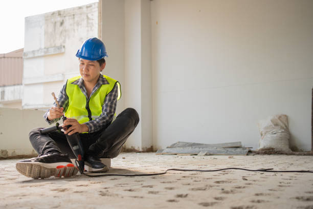 istock Construction worker Using an electric jackhammer to drill perforator equipment making holes before pouring the floor to be strong at construction site, Concept of worker and residential building. 1416090536