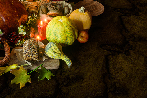 Autumn fall baking background with pumpkins, apples, nuts, food ingredients and seasonal spices on white, creative flat lay. Cooking pumpkin or apple pie for Thanksgiving and autumn holidays.