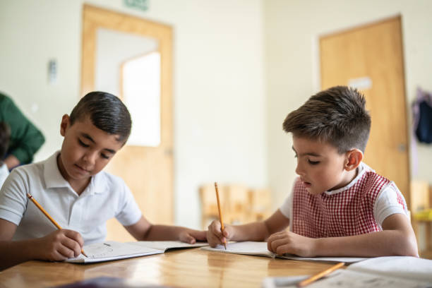 istock Schoolboys writing in the classroom at school 1416096990