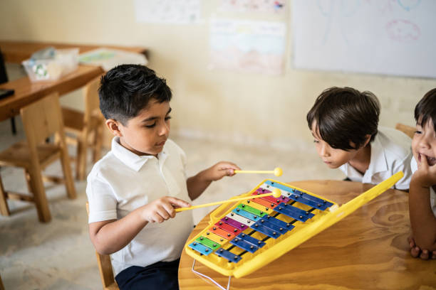 Boy playing musical instrument in the classroom
