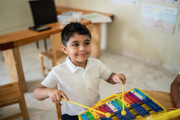 istock Boy playing musical instrument in the classroom 1416097195