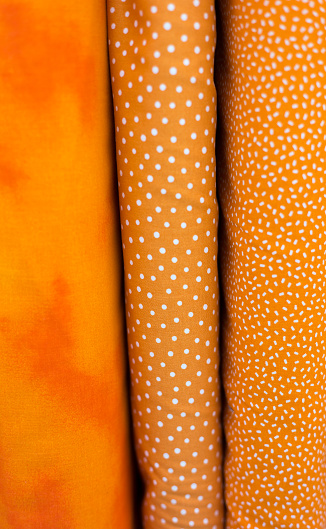Printed Orange Cotton Fabrics Lined Up (Close-Up)