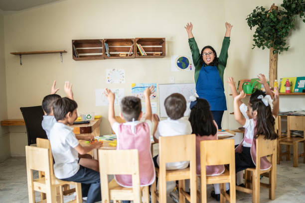 istock Students celebrating with teacher in the classroom 1416097908