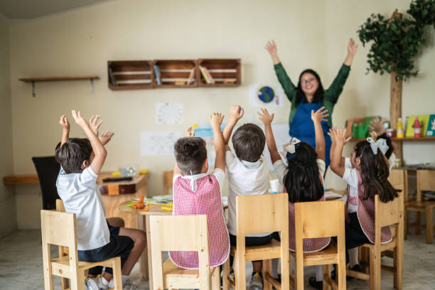istock Students celebrating with teacher in the classroom 1416097931