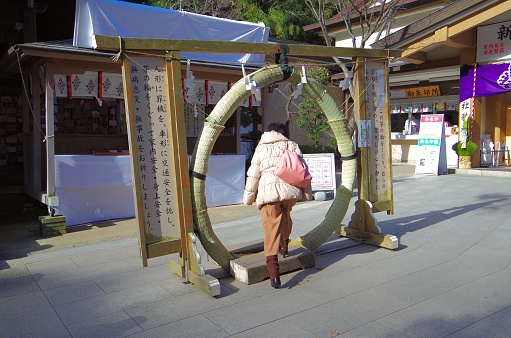 A woman walks through a large circle.
Chinowa-kuguri involves passing through a ring several meters in diameter woven with grass called thatch near the torii gate on the approach to the shrine.Passing through it purifies the mind and body, wards off misfortune, and prays for good health, warding off evil, and the safety of the family.Go through the figure 8 three times.It is held around June 30th and December 31st at many shrines.
<Procedure>
・After entering the shrine, wash your hands and mouth at the chozuya. In front of Chinowa, bow to the main shrine.
・Start with your left foot and go counterclockwise while stepping over the ring with your left foot.Go around the left side of the circle, return to the front and bow once.
・Next, start with your right foot and go clockwise while stepping over the ring with your right foot.After going around the right side of the circle, return to the front and bow once.
・ Once again, turn counterclockwise from the left foot.Stand in front of the circle and bow. At the end, go through the ring and visit the worship hall.