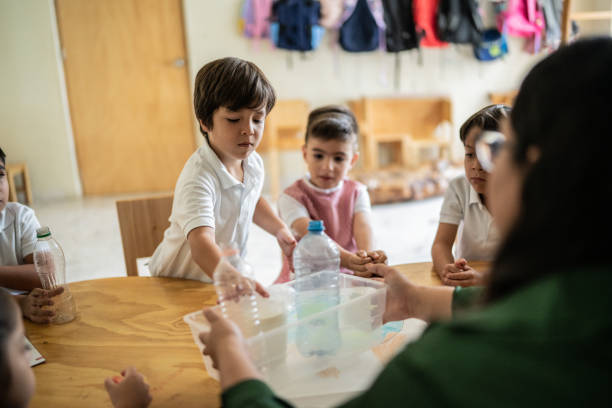 istock Teacher talking to students about recycling in the classroom at school 1416103596