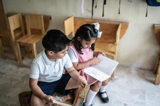 Students reading book in the classroom
