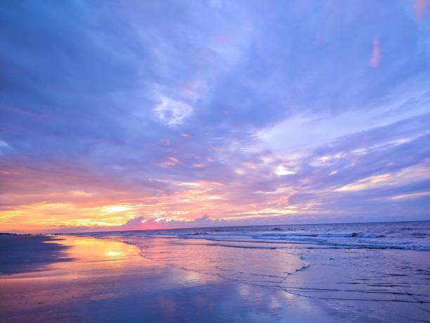 istock Multicolored Beach Sunrise and Reflecting Waves 1416118205
