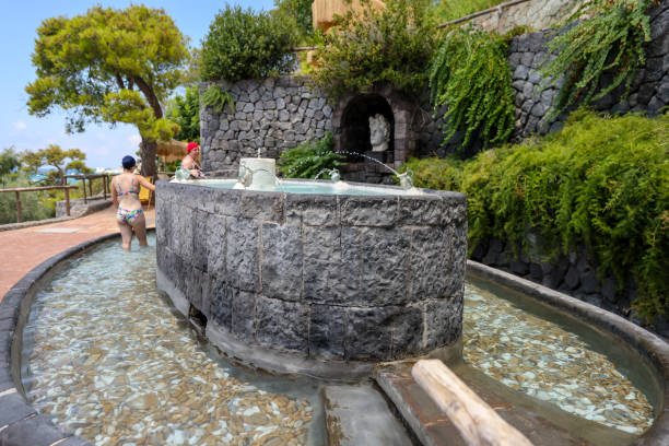 People enjoying the thermal pools and hot springs on the island of Ischia in Italy stock photo