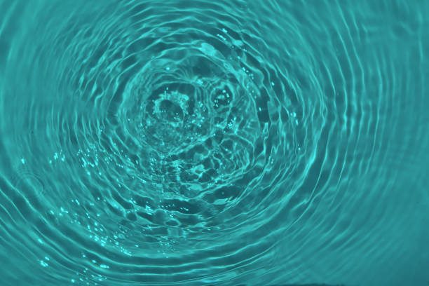 istock Defocus blurred transparent blue colored clear calm water surface texture with splashes and bubble. Trendy abstract nature background. Water wave in sunlight with copy space. Blue watercolor shining. 1416146400