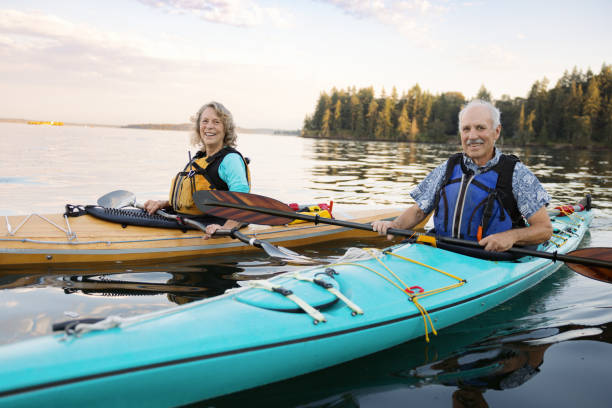 Senior Couple Enjoying Kayaking in the Pacific Northwest stock photo