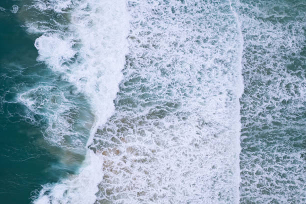 istock Dark sea surface aerial view.Top view blue water ocean waves with white foaming waves crashing on beach background. Amazing sea waves nature background 1416152578