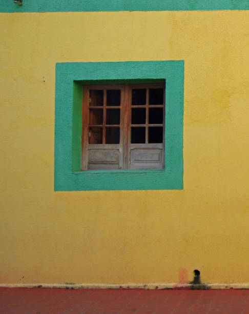 istock Bright Green Trim Window on Bright Yellow Wall 1416154553
