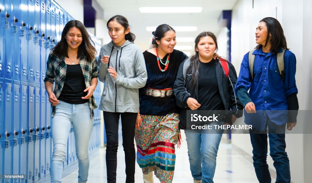 High schoolers walking on a corridor at school Indigenous Peoples of the Americas Stock Photo