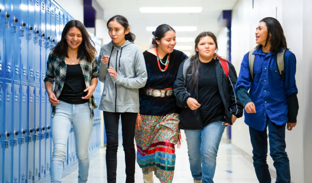 High schoolers walking on a corridor at school stock photo