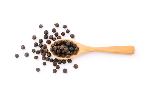 istock Black pepper corn in wooden spoon. 1416164977