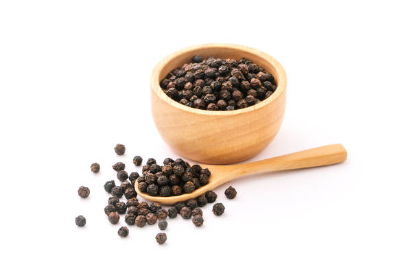 istock Black pepper corn in wooden spoon with bowl. 1416164978