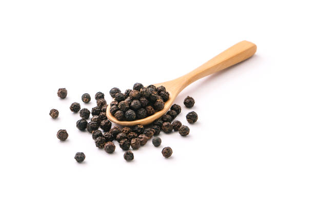istock Black pepper corn in wooden spoon. 1416164979