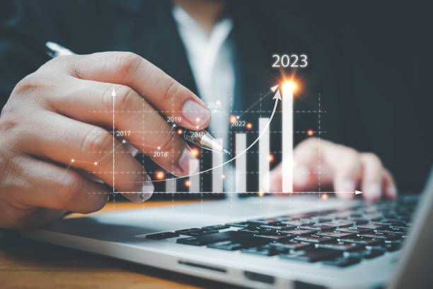 istock Businessman using computer analyzes the profitability of working companies with digital augmented reality graphics, positive indicators in 2023, a business calculates financial data for investments. 1416166458